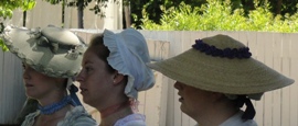 Women wearing colonial era hats