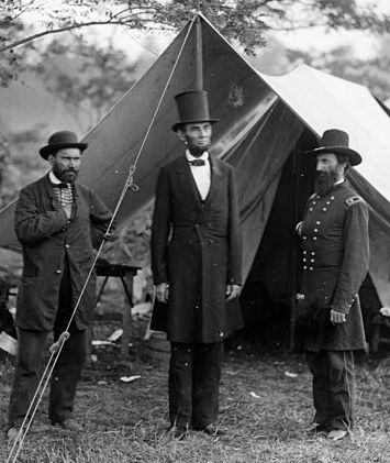 Abraham Lincoln standing outside tent with generals