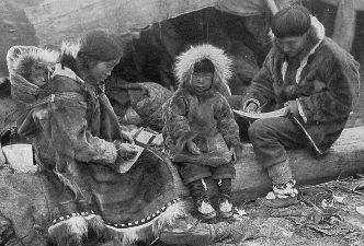 An Inuit family outside their home