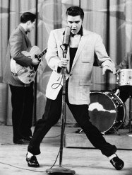 Elvis Presley dancing with mic