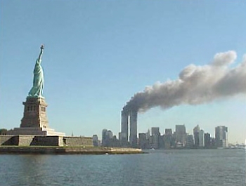 Twin Towers on fire with Statue of Liberty in foreground